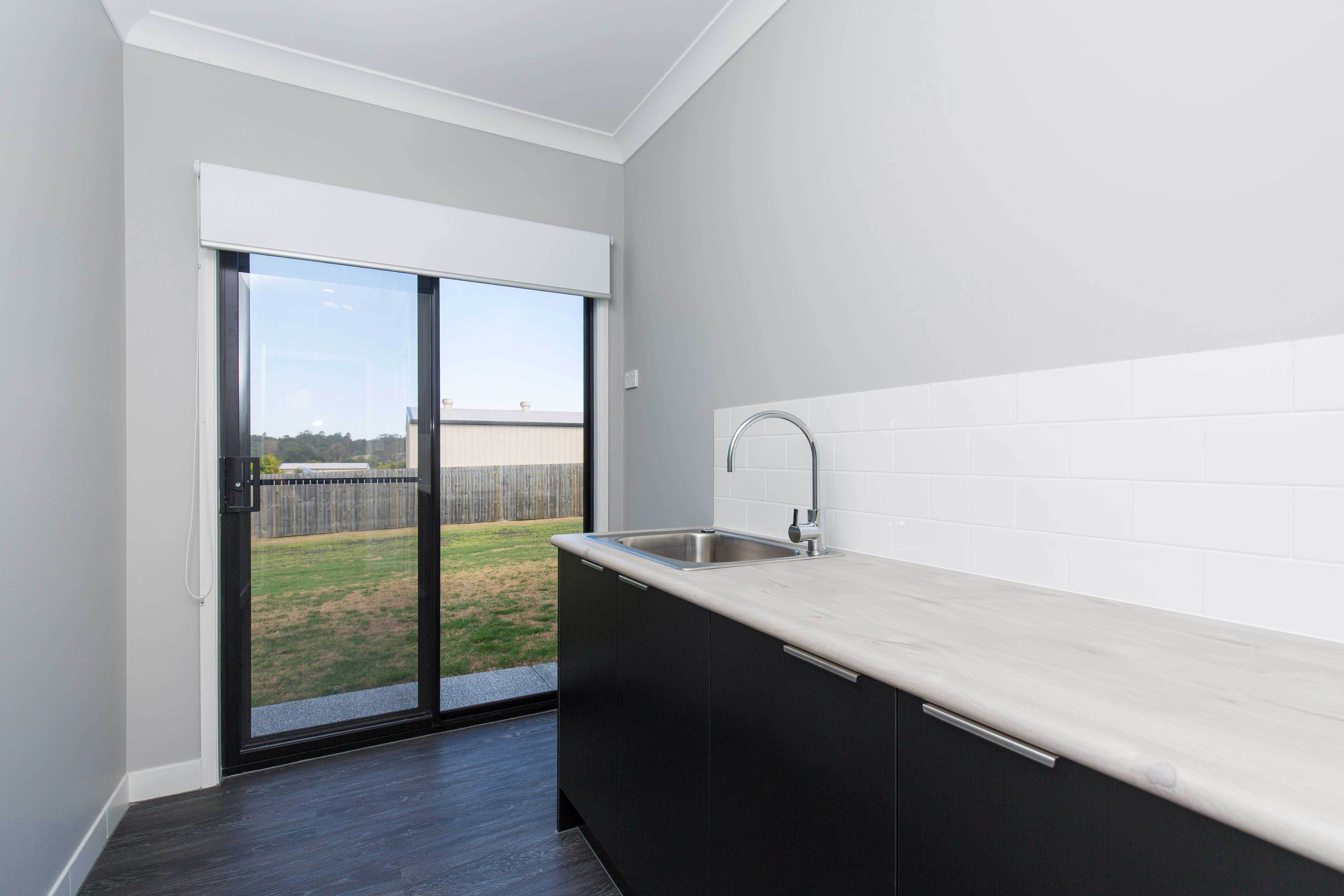 Large laundry with plenty of storage and outdoor access